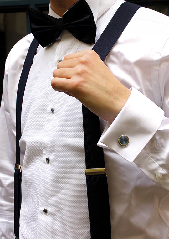 Matching silver and navy blue cufflinks and bib with gold pattern 